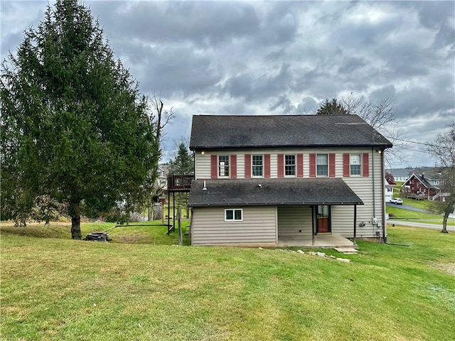 back of property featuring a patio area and a yard