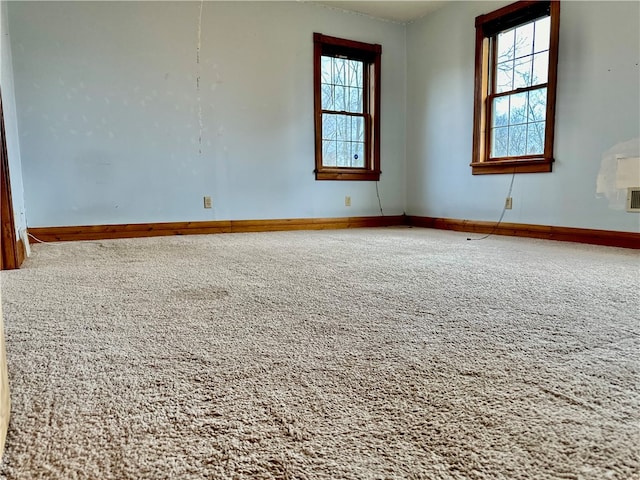 empty room featuring carpet flooring and a healthy amount of sunlight