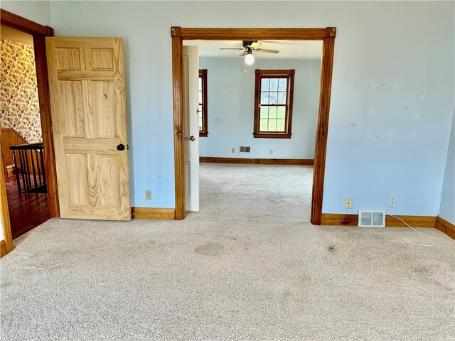 unfurnished room featuring carpet floors and ceiling fan