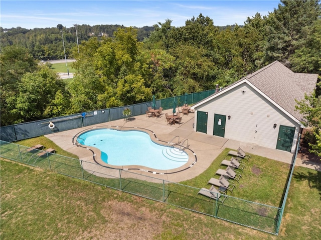 view of swimming pool featuring a yard and a patio