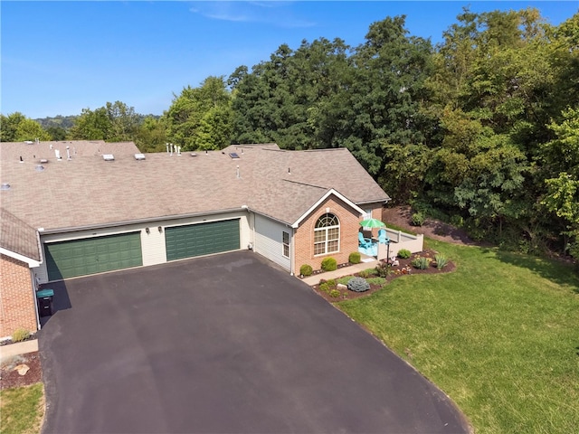 view of front of house with a garage and a front yard