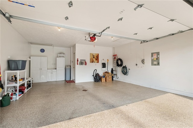 garage featuring electric panel and a garage door opener