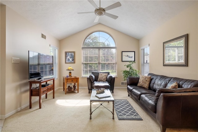 living room with light carpet, a textured ceiling, vaulted ceiling, and ceiling fan