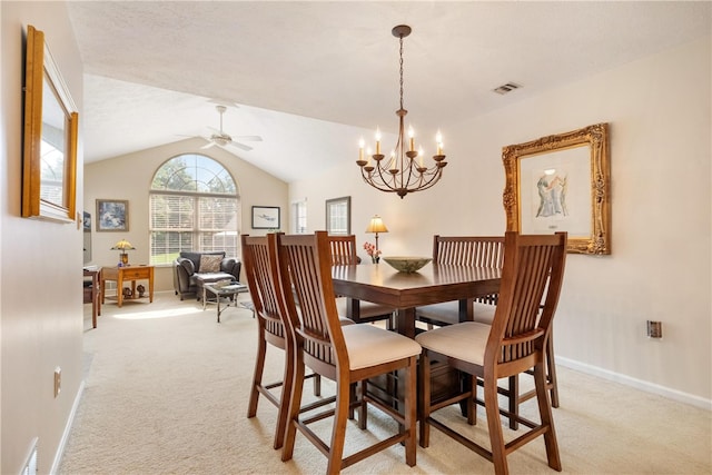 dining space featuring ceiling fan with notable chandelier, light colored carpet, and lofted ceiling