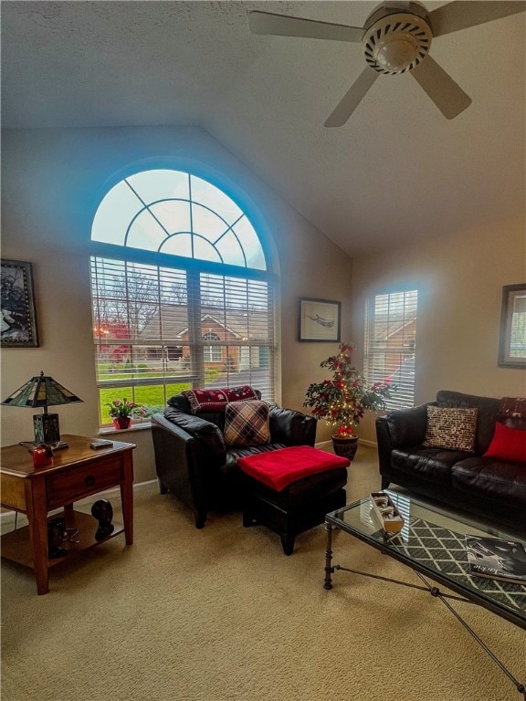 carpeted living room with plenty of natural light, ceiling fan, lofted ceiling, and a textured ceiling