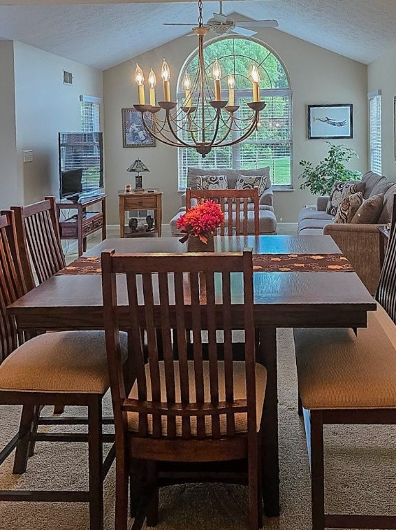 carpeted dining space with a textured ceiling, a chandelier, and lofted ceiling