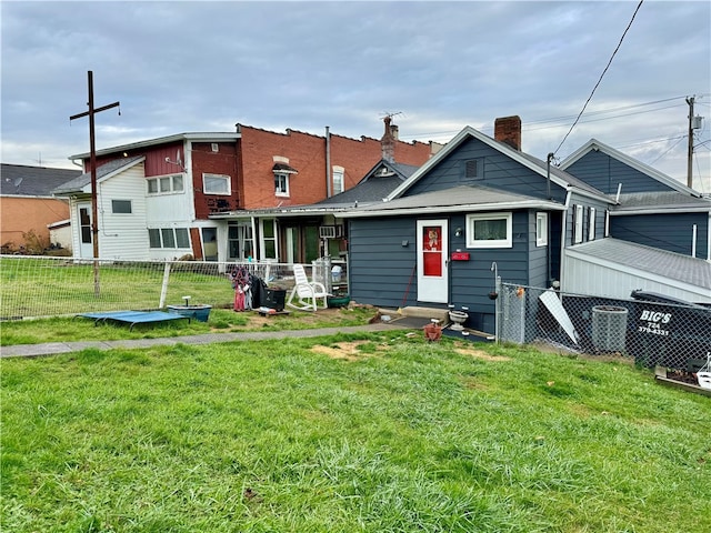 rear view of house with a yard