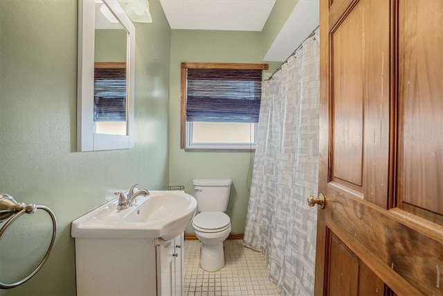 bathroom with tile patterned floors, vanity, and toilet