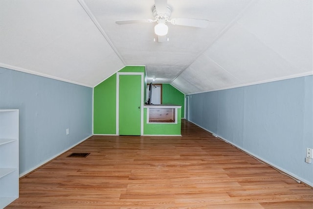 additional living space with lofted ceiling, ceiling fan, and wood-type flooring