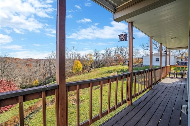 wooden terrace with a lawn