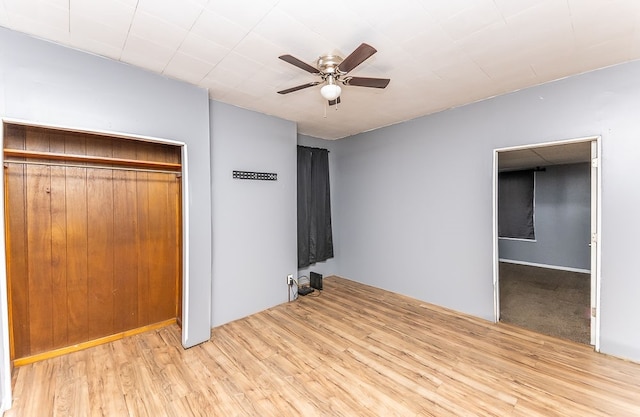 unfurnished bedroom with ceiling fan, a closet, and light hardwood / wood-style floors