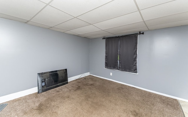 basement with carpet flooring and a drop ceiling