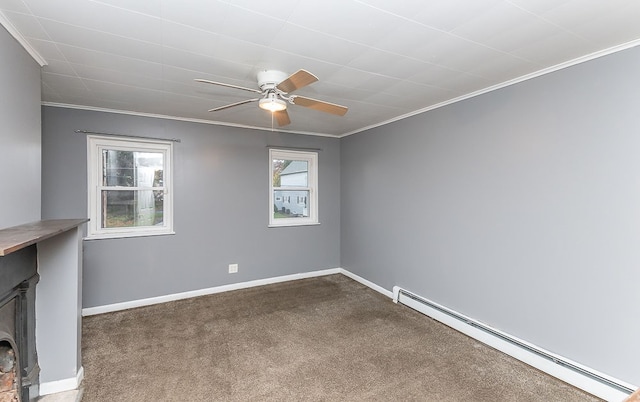 carpeted spare room with a baseboard radiator, ceiling fan, and crown molding