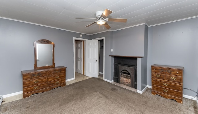 unfurnished living room with carpet, a fireplace, ornamental molding, and ceiling fan