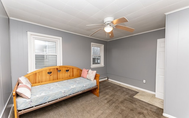 living area with carpet flooring, crown molding, ceiling fan, and a baseboard heating unit