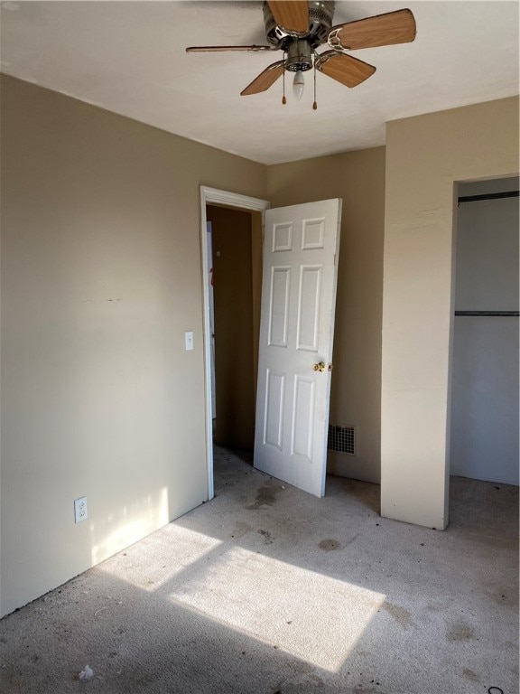 unfurnished bedroom with light colored carpet and ceiling fan