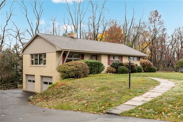 single story home with a front yard and a garage