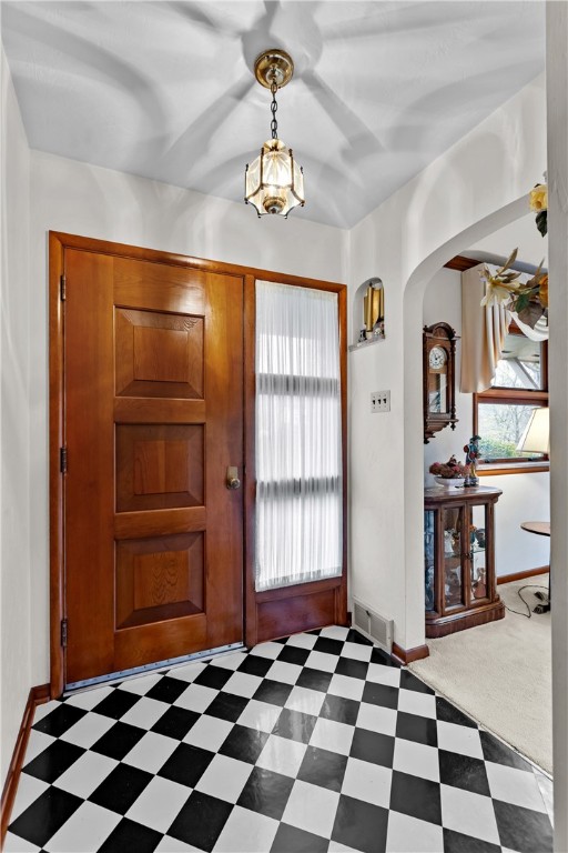 carpeted foyer entrance featuring french doors