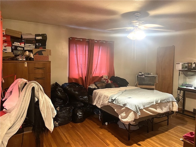 bedroom featuring wood-type flooring and ceiling fan