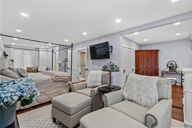 bedroom with light hardwood / wood-style floors and ensuite bathroom