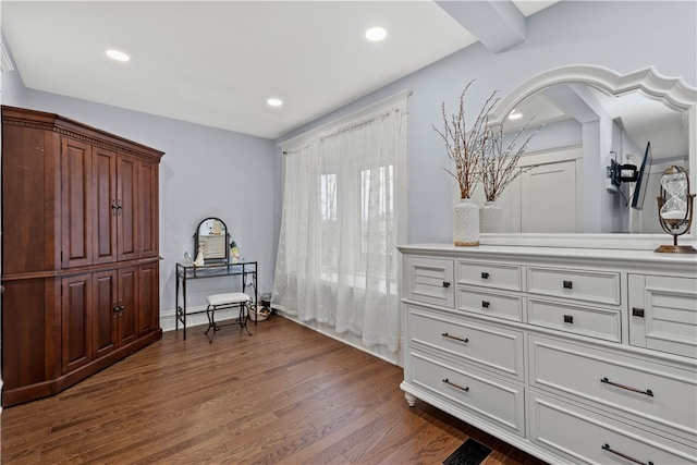 interior space featuring beamed ceiling and dark hardwood / wood-style floors