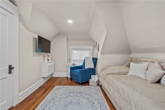 bedroom with vaulted ceiling and dark wood-type flooring