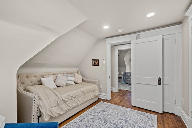 interior space with vaulted ceiling and hardwood / wood-style flooring