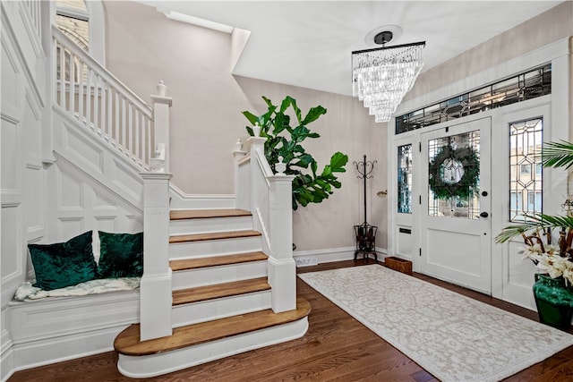 foyer with a chandelier and dark wood-type flooring