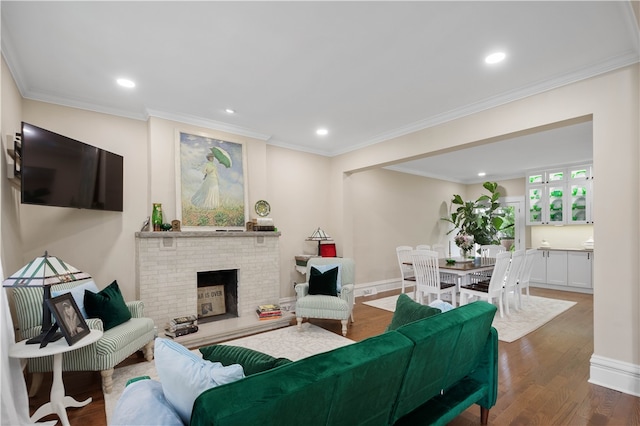 living room featuring crown molding, dark wood-type flooring, and a brick fireplace