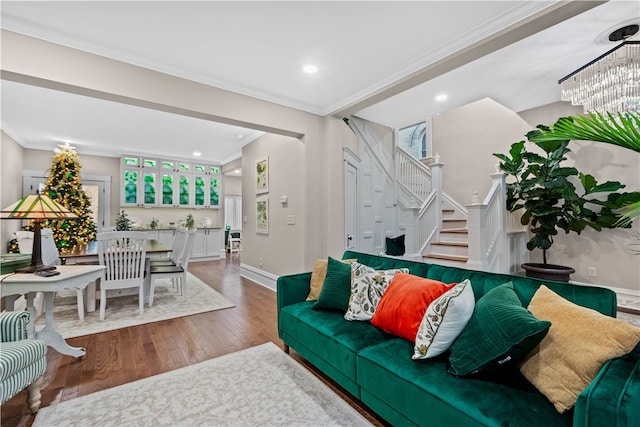 living room featuring plenty of natural light, wood-type flooring, and ornamental molding