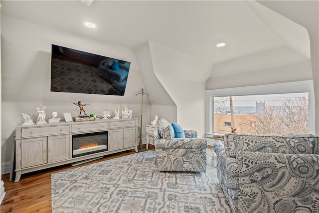 bedroom featuring light hardwood / wood-style floors and lofted ceiling