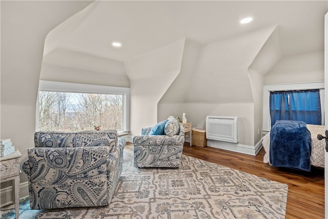 living area with hardwood / wood-style floors and lofted ceiling