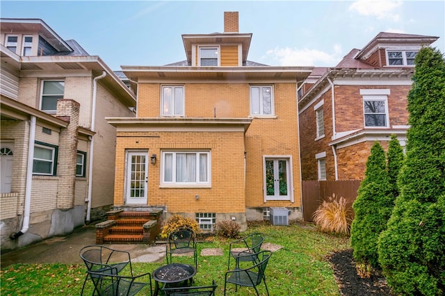 rear view of house with central AC unit