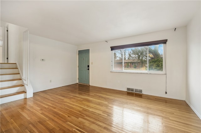 empty room with light hardwood / wood-style floors