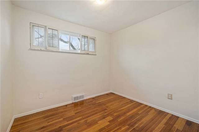 unfurnished room with wood-type flooring