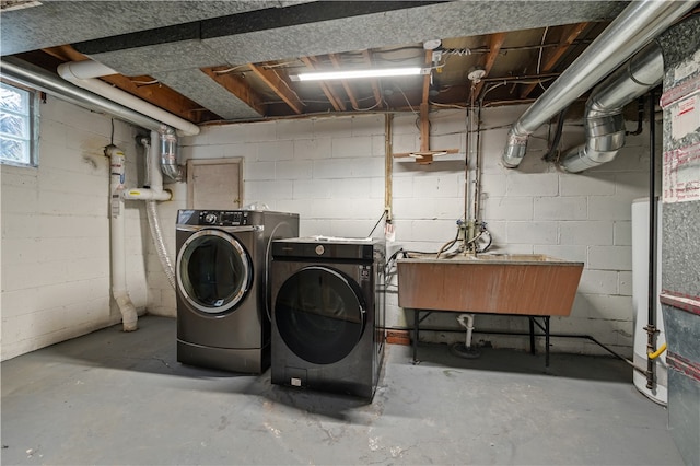 clothes washing area featuring washing machine and dryer and sink