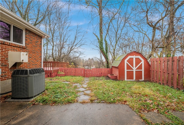 view of yard featuring a storage shed and central AC