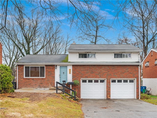 view of front of property with a garage and a front lawn