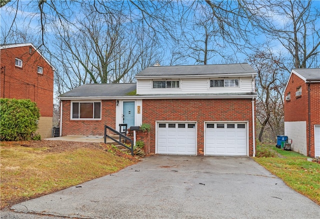 view of front of property with a garage and a front lawn