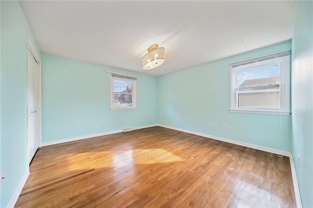 empty room with hardwood / wood-style flooring