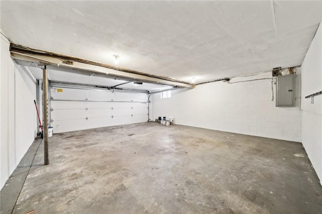 garage featuring electric panel and a garage door opener