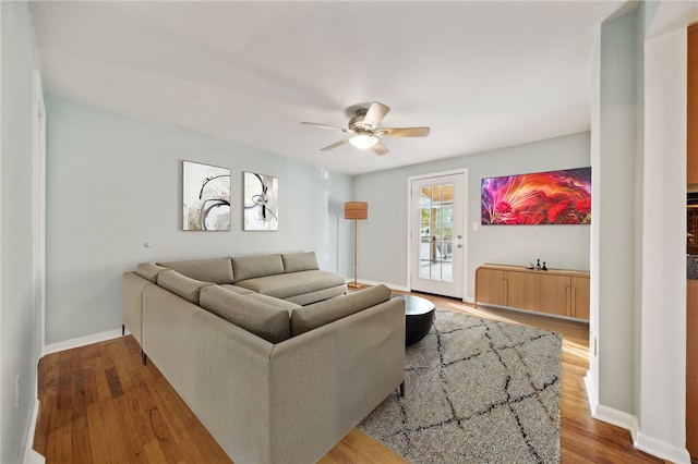 living room with ceiling fan and wood-type flooring