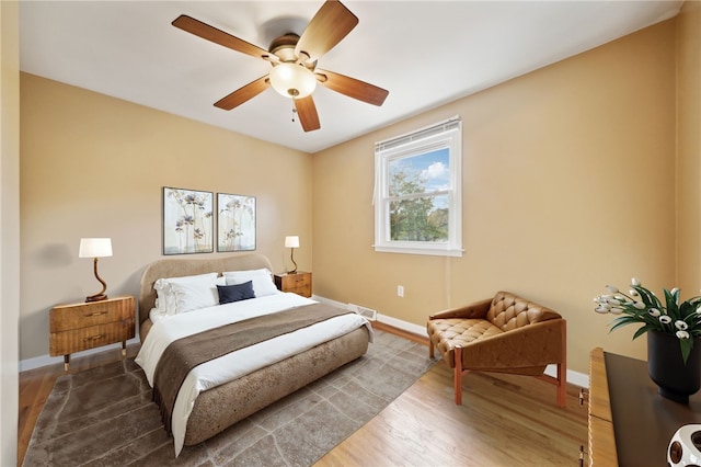 bedroom with hardwood / wood-style floors and ceiling fan