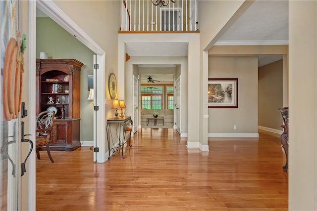 entrance foyer featuring crown molding, light hardwood / wood-style flooring, and ceiling fan