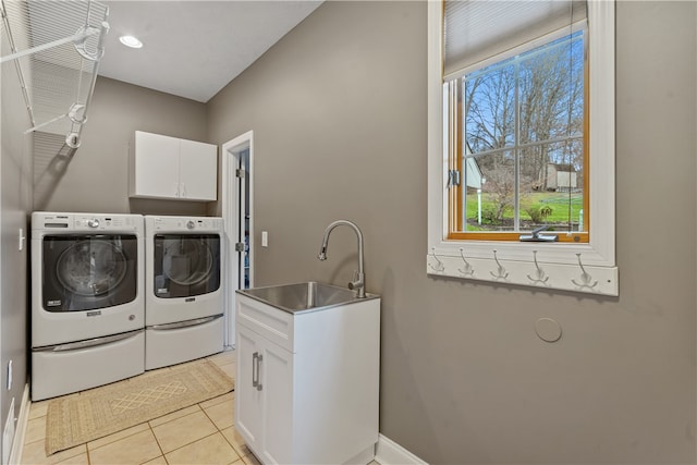 clothes washing area featuring cabinets, light tile patterned floors, separate washer and dryer, and sink