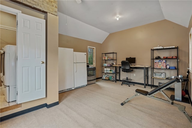 workout area featuring light carpet, washer / clothes dryer, and vaulted ceiling