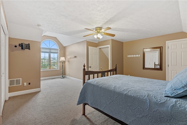 bedroom featuring a textured ceiling, ceiling fan, light colored carpet, and lofted ceiling