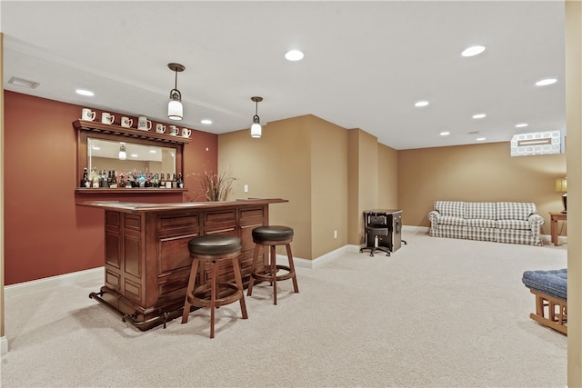 bar with light colored carpet and hanging light fixtures