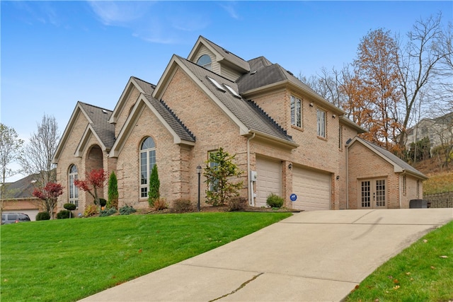 view of front of house with a garage and a front yard