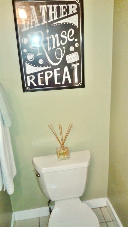 bathroom with tile patterned flooring and toilet